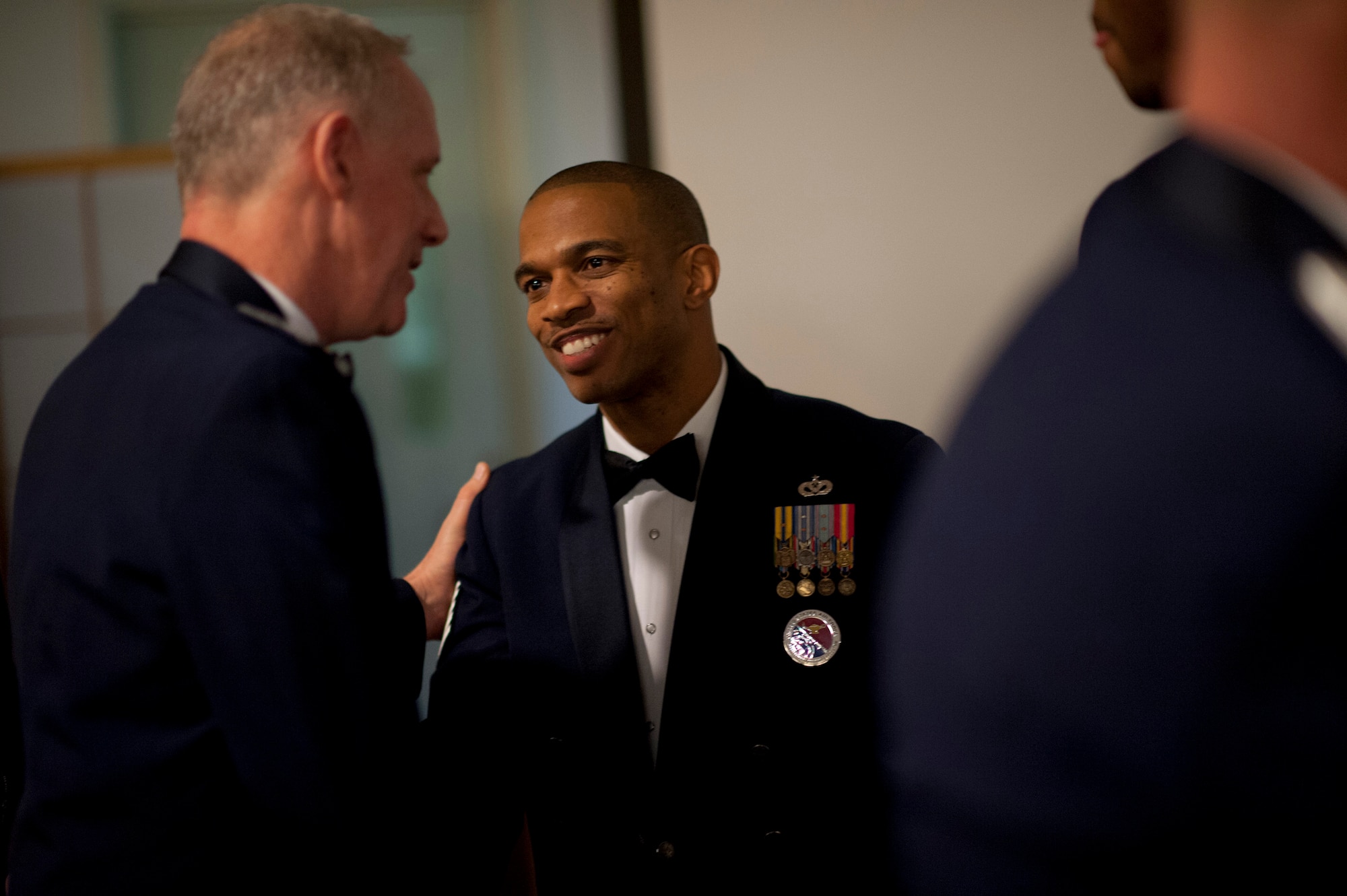 YOKOTA AIR BASE, Japan -- Col. Otto Feather (left), 374th Airlift Wing commander, shakes hands with Tech. Sgt. Andy Gilbert, Airman Leadership School instructor, during the ALS Class 12-B graduation at the Yokota Enlisted Club, Yokota Air Base, Japan, Feb. 9, 2012. This graduation was Gilbert's last as an instructor.  Among his more notable accomplishments, Gilbert was the 2010 Air Force Enlisted Professional Military Education NCO of the Year. (U.S. Air Force photo/Staff Sgt. Samuel Morse)