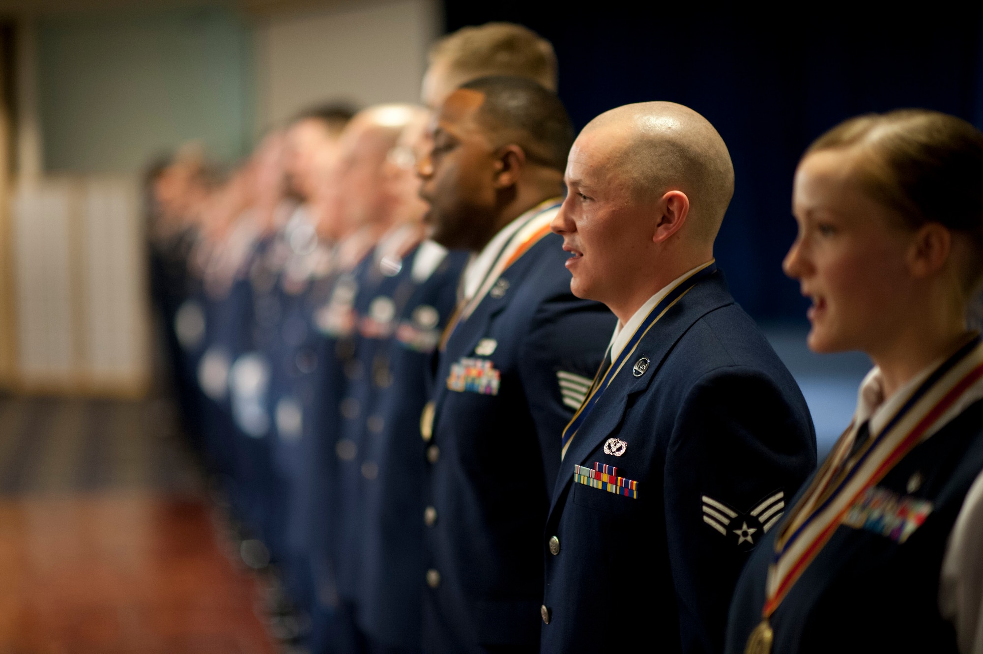 YOKOTA AIR BASE, Japan -- Senior Airman Sheldon Dunn Jr., 374th Civil Engineer Squadron, sings the Air Force Song with his classmates of Airman Leadership School Class 12-B at the Yokota Enlisted Club, Yokota Air Base, Japan, Feb. 9, 2012. Dunn was the recipient of the John L. Levitow Award, the highest recognition in Air Force professional military education. (U.S. Air Force photo/Staff Sgt. Samuel Morse)