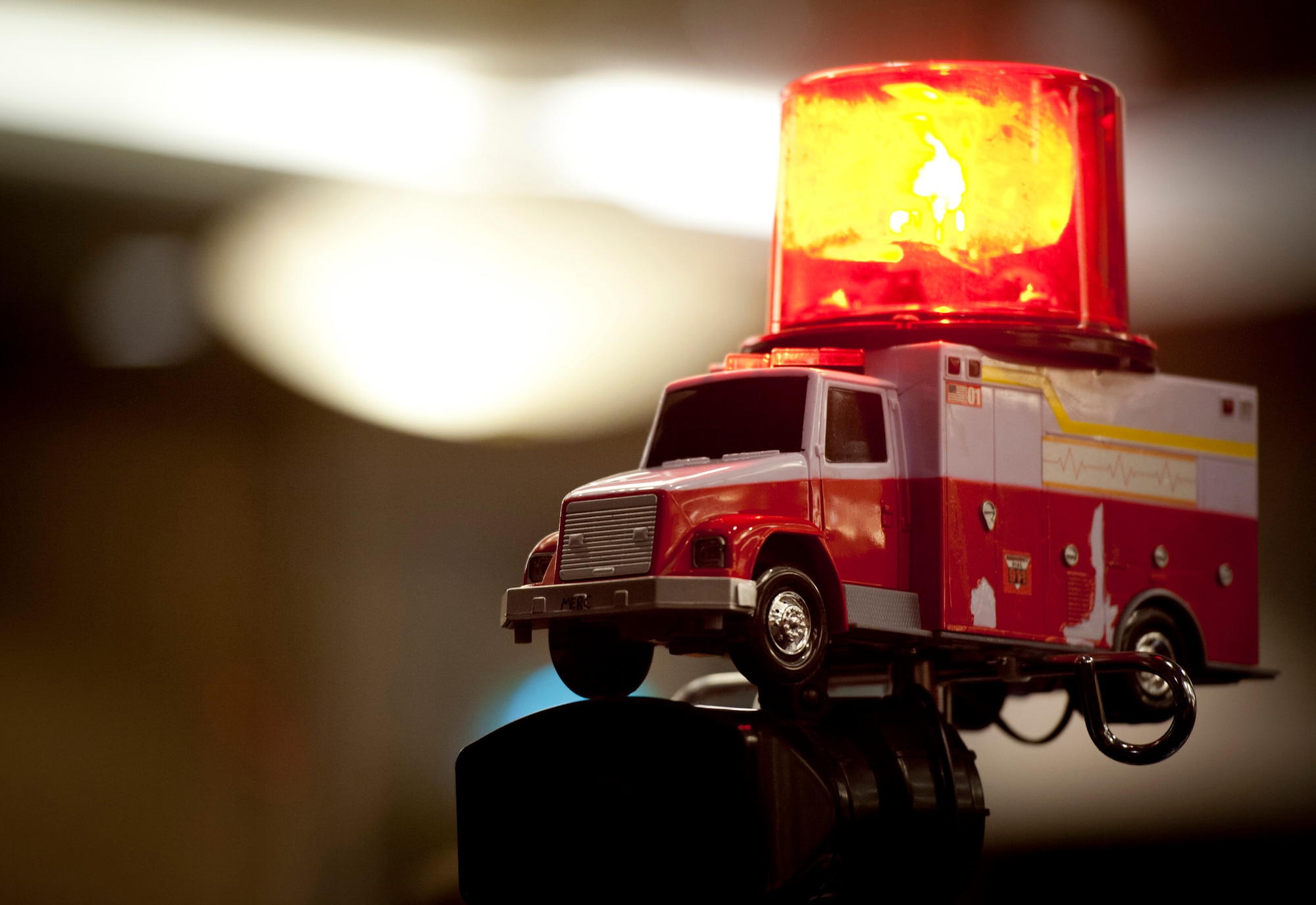 YOKOTA AIR BASE, Japan -- A model ambulance with a siren and flashing light sits prominently at the 374th Medical Group table during the Airman Leadership School Class 12-B graduation at the Yokota Enlisted Club, Yokota Air Base, Japan, Feb. 9, 2012. (U.S. Air Force photo/Staff Sgt. Samuel Morse)