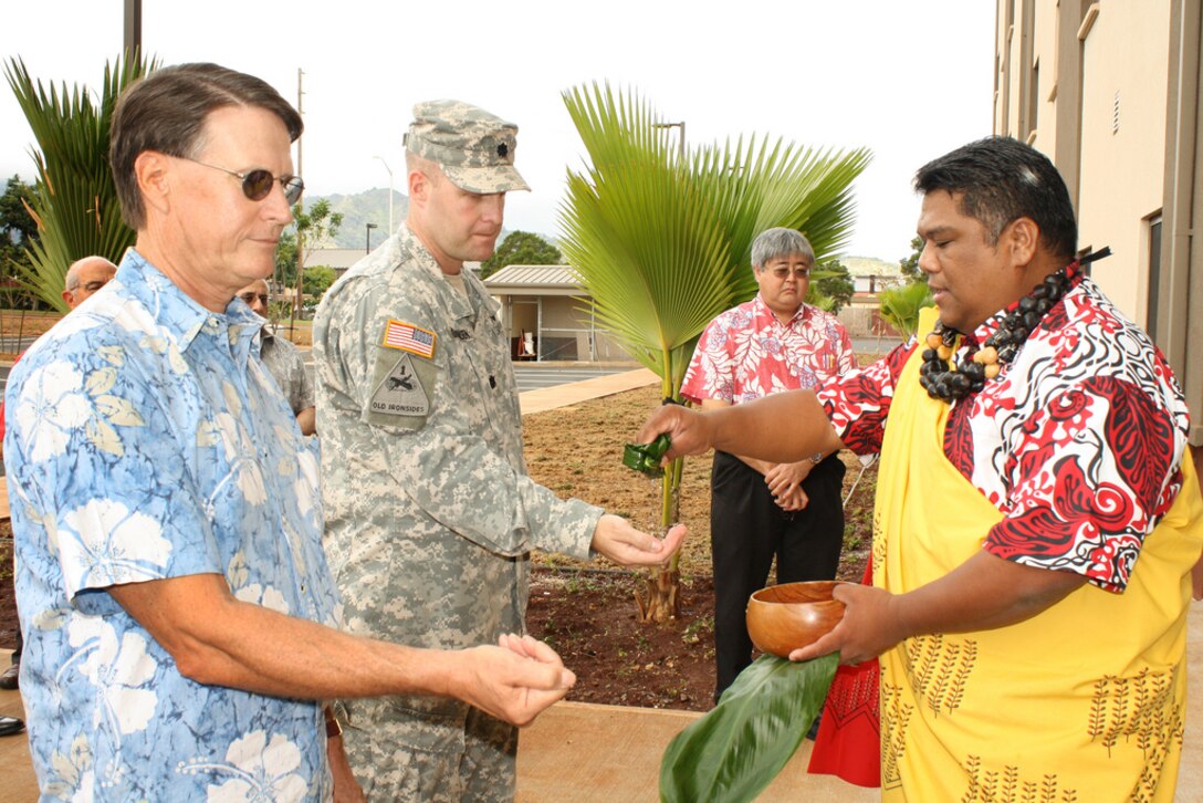 Directorate of Public Works Director Bob Eastwood and Honolulu District Commander Lt. Col. Douglas Guttormsen participate in a traditional maile lei untying and blessing ceremony held Dec. 15  for the new Unaccompanied Enlisted Personnel Housing at Schofield Barracks. The blessing was presided over by Kahu La`akea Arista. The $29.18 million contract was awarded Sept. 24, 2009 to Hawaiian Dredging Construction Company, Inc. by the U.S. Army Corps of Engineers, Honolulu District.  The project consisted of designing and constructing a six-story barracks to house 192 personnel in a standard one plus one configuration.