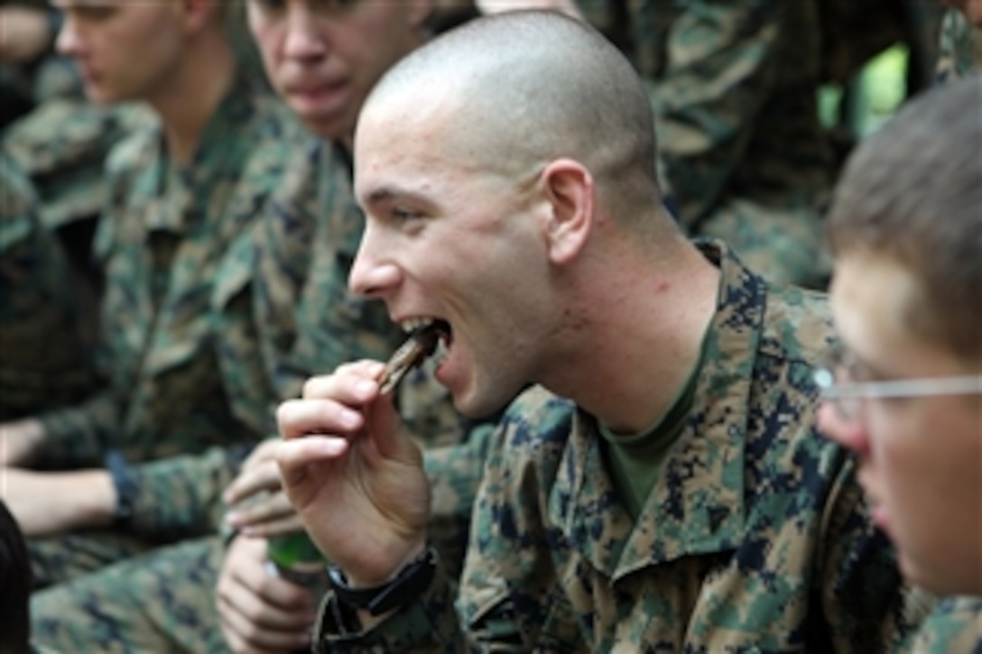 A Marine with Company B, Battalion Landing Team 1st Battalion, 4th Marines, 31st Marine Expeditionary Unit, eats a cooked insect during a jungle survival class on Feb. 13, 2012.  The survival instruction taught by members of the Royal Thai Marine Reconnaissance educated U.S. and Republic of Korean Marines on finding sustenance and tools in the jungle environment.  The class is part of exercise Cobra Gold 2012.  The exercise is a multi-lateral event focused on strengthening the interoperability of all participating military forces.  