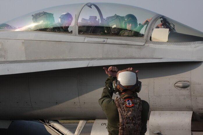 Maj. Gen. William D. Beydler, commanding general, 1st Marine Aircraft Wing, III Marine Expeditionary Force watches as a Marine All-Weather Fighter Attack Squadron 242 fixed-aircraft wing mechanic during Exercise Cobra Gold 2012. Cobra Gold is a reoccurring multinational and multiservice exercise hosted by the Kingdom of Thailand. It is designed to advance regional security by exercising a multinational force from nations sharing common goals and security commitments in the Asia-Pacific region.