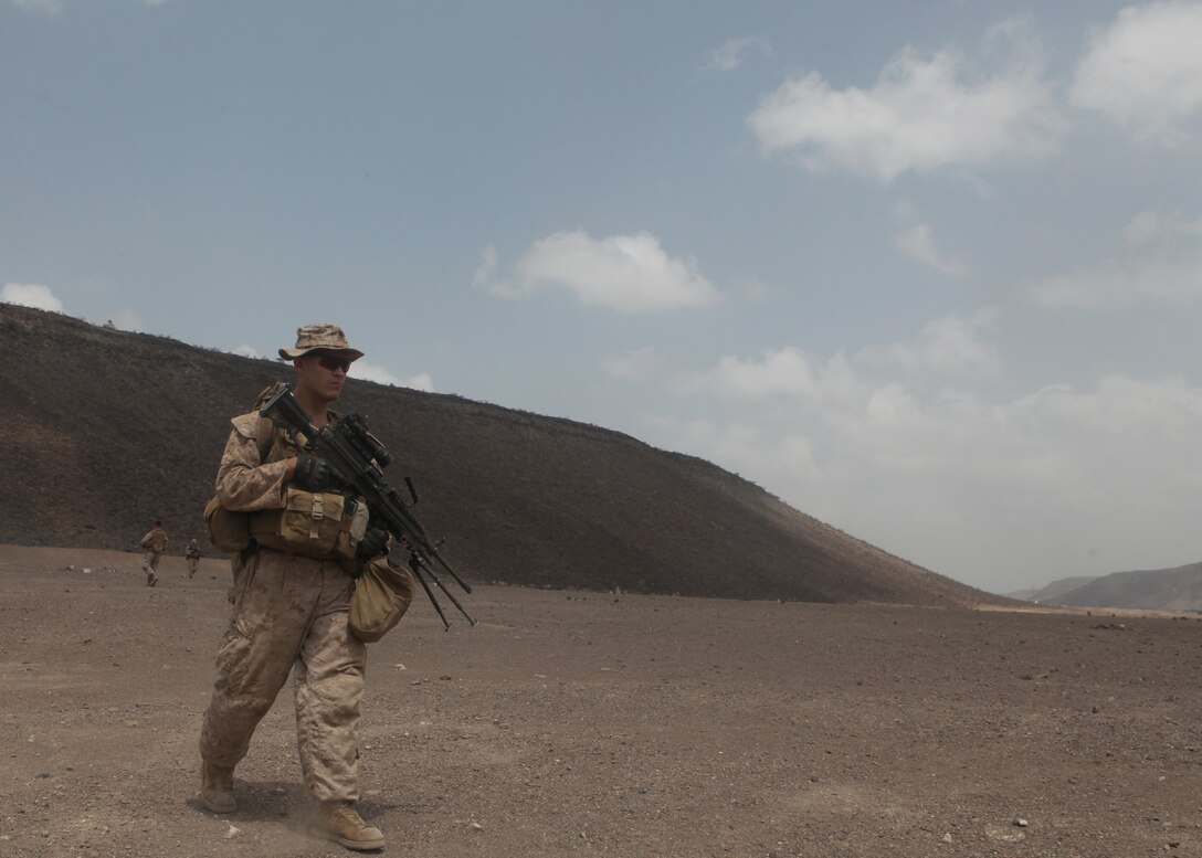 CAMP LEMONNIER, DJIBOUTI (Oct. 7, 2011) Lance Cpl. Grant E. Dennington, a squad automatic weapon gunner with Echo Company, Battalion Landing Team, 2nd Battalion, 2nd Marine Regiment, 22nd Marine Expeditionary Unit (MEU), and Austell, Ga., native, patrols ashore near Camp Lemonnier, Djibouti, Oct. 7, 2011. Echo Company spent six days in Djibouti conducting many different training exercises such as, squad and platoon attacks, night-fire, mortar, and demolition exercises. The 22nd MEU is currently deployed as part of the Bataan Amphibious Ready Group (BATARG) as the U.S. Central Command theatre reserve force, also providing support for maritime security operations and theater security cooperation efforts in the U.S. 5th Fleet area of responsibility. (Marine Corps photo by Cpl. Dwight A. Henderson/Released)