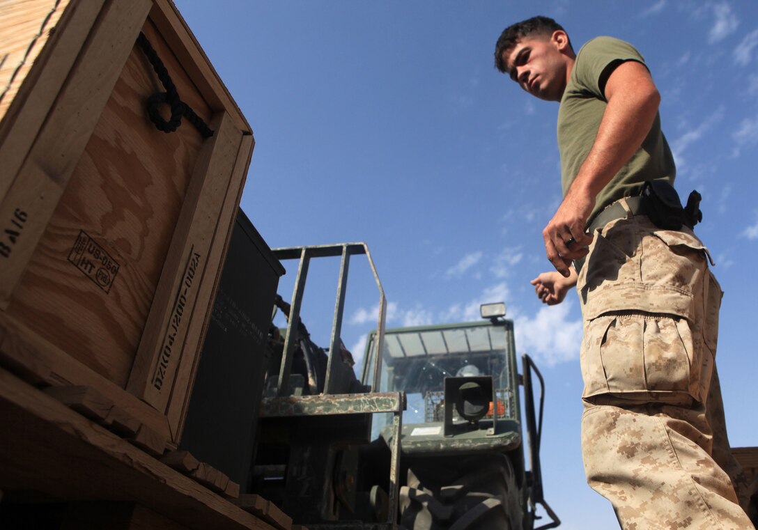 111021-N-SY711-069 CAMP LEATHERNECK, Afghanistan (October 21, 2011) Lance Cpl. Timothy Oehlert, an ammunition technician with Supply Company, Marine Support Battalion guides a forklift carrying ammunition at the Field Ammunition Supply Point, Camp Leatherneck, Afghanistan, October 21.  The FASP Marines are responsible for off loading, tracking and transporting ammunition deliveries to the all FOBS within Regional Command Southwest. (Official U.S. Navy photo by Mass Communication Specialist 2nd Class Matt Snodgrass/Released)
