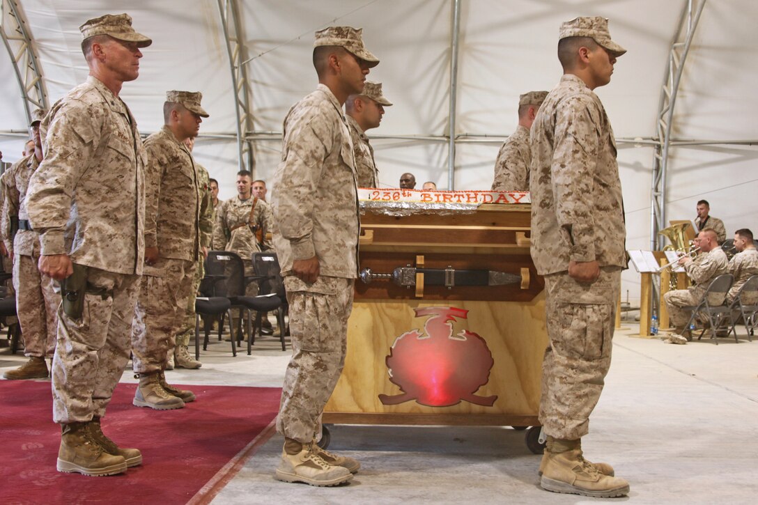 Marines present a birthday cake to Marines aboard Camp Leatherneck, Helmand province, November 10, at the 236th Marine Corps birthday ceremony. It is tradition for the oldest Marine in attendance to receive the first piece of cake and for that piece to then be passed on to the youngest Marine. This symbolizes the passing of history and tradition throughout the Marine Corps. 
