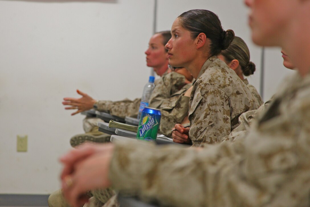 Sgt. Jessica Lugo, assigned to Female Engagement Team 6 in Sangin district, Helmand province, and a native of Los Angeles, listens to other Marines with FET talk about their experiences so far on the deployment. The Marines assigned to the team travel to Camp Leatherneck every 45 days for reset training, before going back to the battalions they are assigned to.