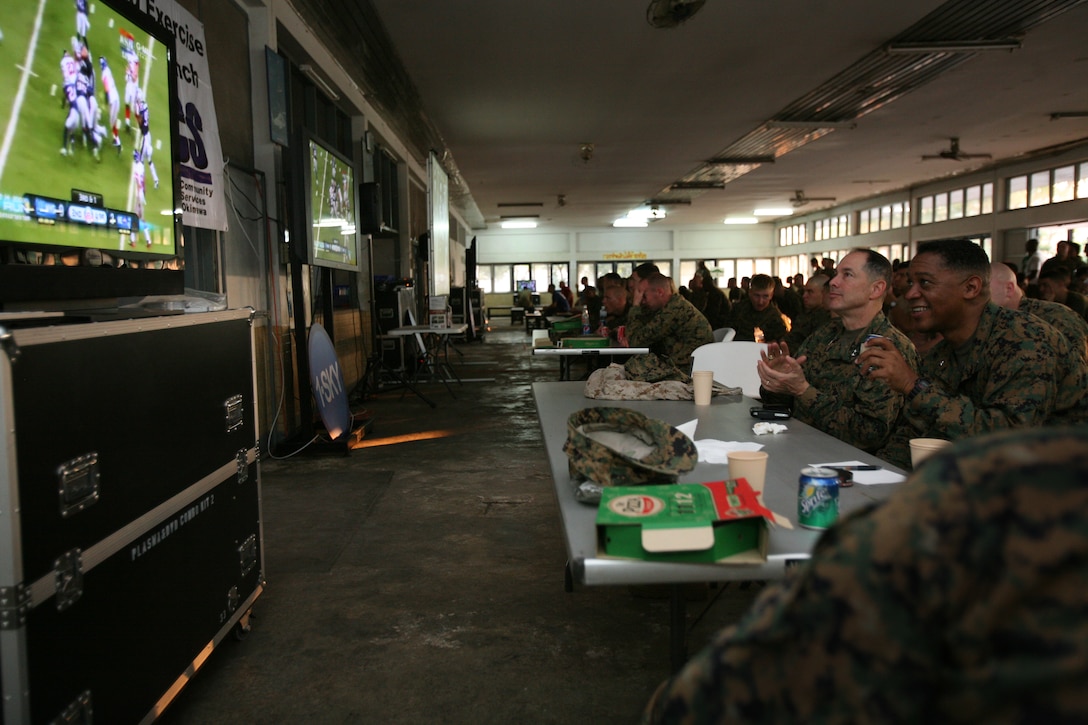 Maj. Gen. Peter J. Talleri, commanding general of Marine Corps Installations Pacific and Marine Corps Base Camp Butler, and Brig. Gen. Craig Q. Crenshaw, commanding general of 3rd Marine Logistics Group, watch Super Bowl XLVI here, Feb 6. The Marines and Sailors participating in Exercise Cobra Gold 2012 were able to watch the Super Bowl through satellite television provided by MCCS Deployed Exercise Support.