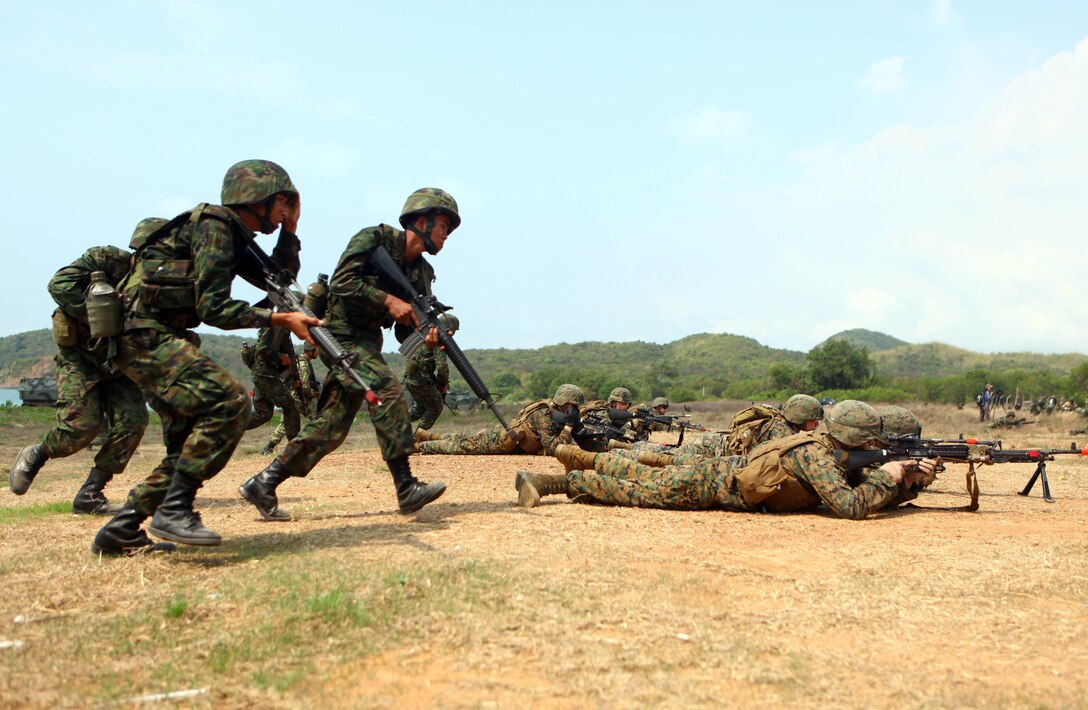 A Marine Company A, Battalion Landing Team 1st Battalion, 4th Marines, 31st Marine Expeditionary Unit, moves into position as Royal Thai Marines provide security during a small boat raid here, Feb. 8. The Marines were conducting the boat raid during Exercise Cobra Gold 2012, an annual exercise hosted by the Kingdom of Thailand. CG 2012 demonstrates the resolve of the U.S. and participating nations to increase interoperability and promote security and peace throughout the Asia-Pacific region. The 31st MEU is the U.S.'s expeditionary force in readiness in the Asia-Pacific region.