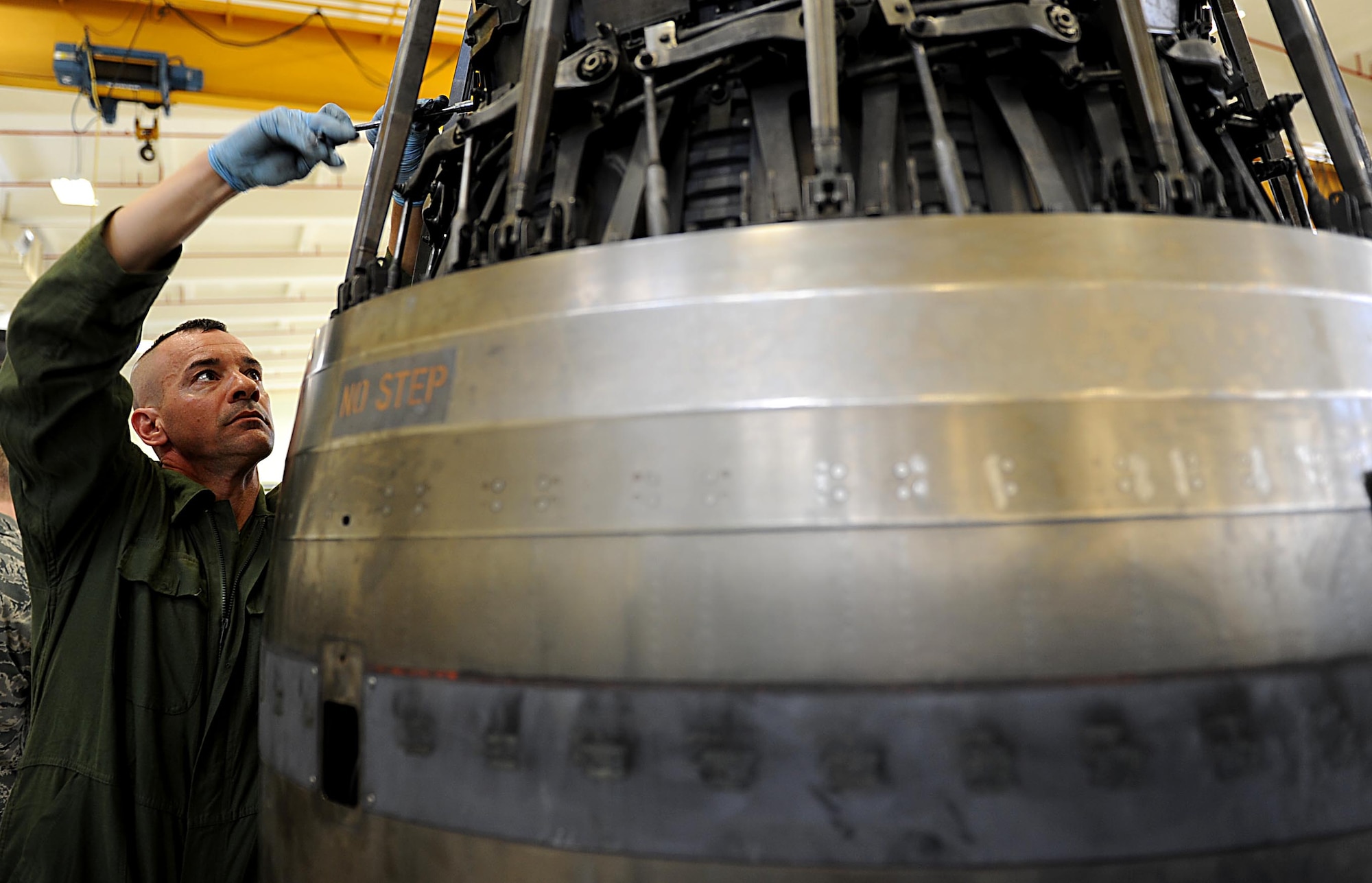 U.S. Air Force Chief Master Sgt. Mark Marson, 18th Wing Command Chief Master Sgt., participates in taking apart an engine augmenter on Kadena Air Base, Feb. 15. 2012. Chief Marson along with U.S. Air Force Brig. Gen. Matthew Molloy, 18th Wing commander, visited the 18th Component Maintenance Squadron to work alongside Airmen and learn a little bit about what they do on a daily basis. (U.S. Air Force photo by Airman 1st Class Brooke P. Beers) 