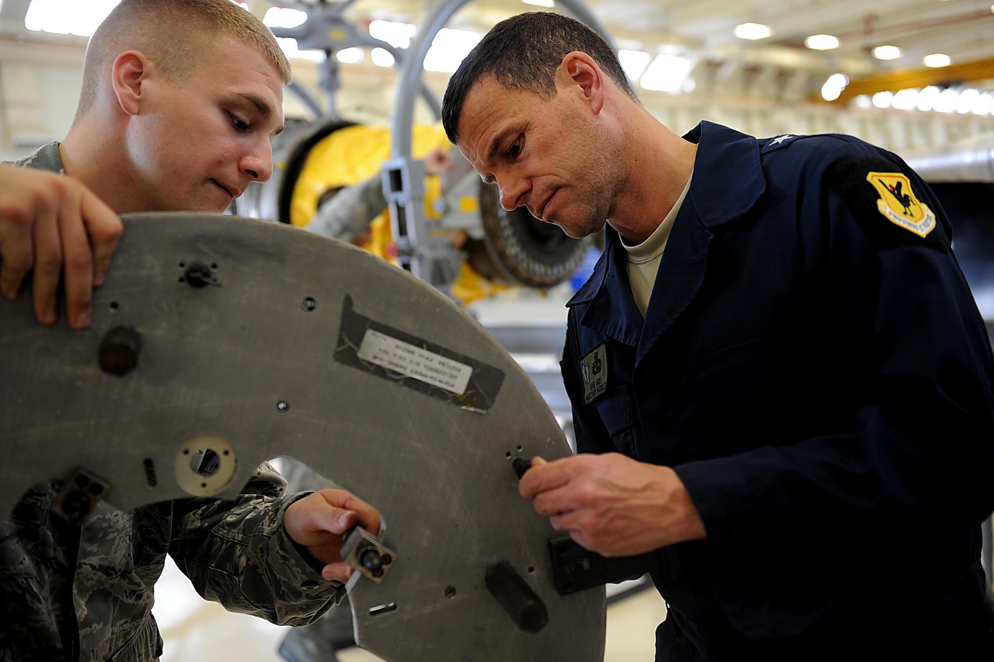 U.S. Air Force Brig. Gen. Matthew Molloy looks over a part before attaching it to a Prat and Whitney F100-220 afterburning engine on Kadena Air Base, Feb. 15, 2012. The engine is used to power the U.S. Air Force F-15 Eagle fighter jet. (U.S. Air Force photo by Airman 1st Class Brooke P. Beers) 