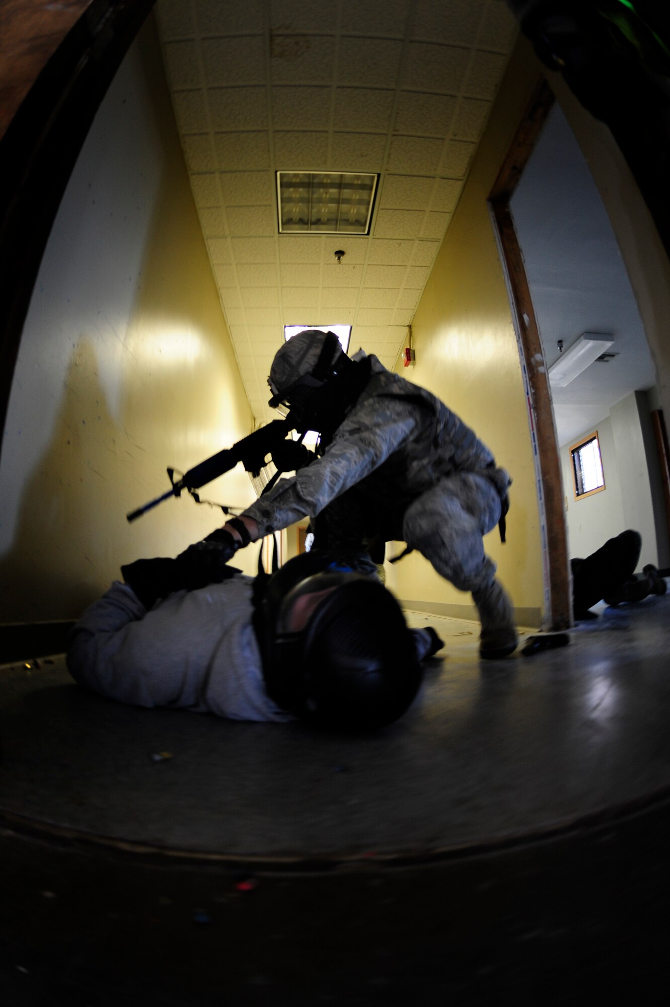 VANDENBERG AIR FORCE BASE, Calif. -- While searching a subject, a 30th Security Forces Squadron member, checks for weapons during an active shooter training course here Thursday, Feb. 2, 2012. The 30th SFS trainers emphasize the speed of action, safely securing an area and ensuring the objective is completed properly. (U.S. Air Force photo/Staff Sgt. Andrew Satran) 

 