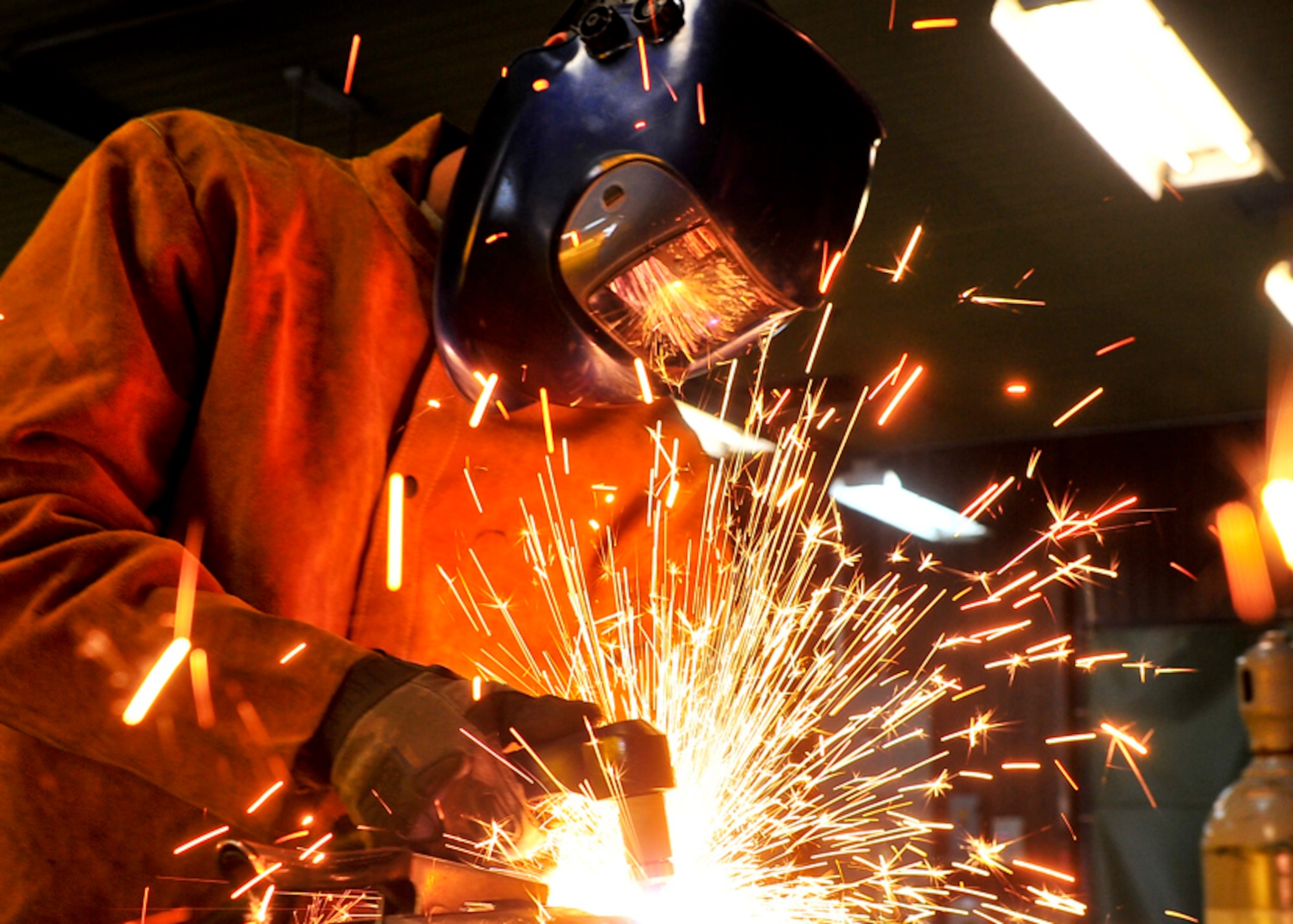 Senior Airman James Turner, 51st Maintenance Group aircraft metal technology journeyman, uses a plasma cutter to cut a piece of excess metal   Feb. 12, 2012. The Plasma Cutter works by sending pressurized gas through a small channel which contains negatively charged electrodes. Once power is applied and the tip of the nozzle is applied to metal the connection creates a circuit. As the inert gas passes through the channel the spark heats the gas until it reaches the fourth state of matter in which the reaction creates a stream of directed plasma, approximately 30,000 degrees. (U.S. Air Force photo/Senior Airman Adam Grant)