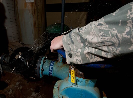 Senior Airman Matthew Atton, 28th Civil Engineer Squadron water and fuels maintenance technician, turns off water flow to the Bellamy Fitness Center’s swimming pool strainer during routine maintenance on Ellsworth Air Force Base, S.D., Feb. 3, 2012. The water’s pH levels are tested to determine if they need more acidic or basic chemicals to ensure a safe and clean pool for swimmers. (U.S. Air Force photo by Airman 1st Class Zachary Hada/Released)