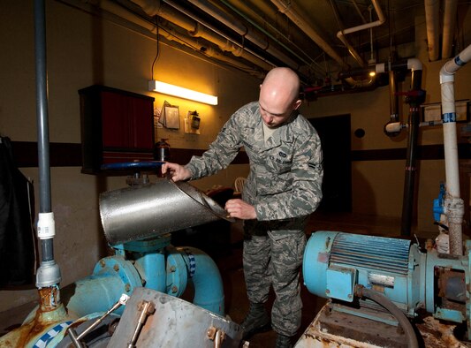 Airman 1st Class Anthony Russell, 28th Civil Engineer Squadron water fuels maintenance technician, removes and cleans a water strainer for the Base pool at the Bellamy Fitness Center on Ellsworth Air Force Base, S.D., Feb. 3, 2012. Water fuel technicians are responsible for the base’s interior and exterior plumbing to ensure Airmen are provided with high quality water sources. (U.S. Air Force photo by Airman 1st Class Zachary Hada/Released)