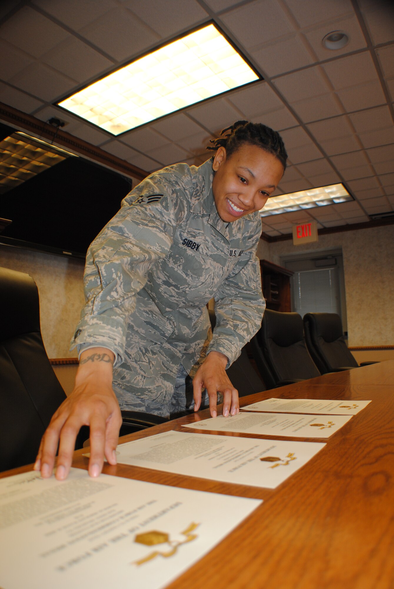 Senior Airman Ashley Sibby organizes Air Force Commendation citations Feb. 14, 2012, at the 319th Mission Support Group headquarters conference room on Grand Forks Air Force Base, N.D. Sibby was named Warrior of the Week  for the week covering Feb. 12 to Feb. 18.  Sibby is a knowledge operations manager with the 319th MSG. Airman Sibby helps process between 50 to 75 awards and decorations per month. (U.S. Air Force photo/Senior Airman Luis Loza Gutierrez)