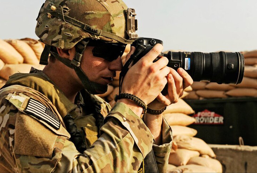 Staff Sgt. Ryan Crane, Air Force photographer and photojournalist, covers combat action while deployed to Afghanistan on July 15, 2012. Crane, from 375th Air Mobility Wing Public Affairs at Scott Air Force Base, Ill., was named the Defense Video and Imagery Distribution System Journalist of the Month for July 2011, and has also won the Air Mobility Command Photographer of the Year for 2011. (U.S. Air Force Photo)