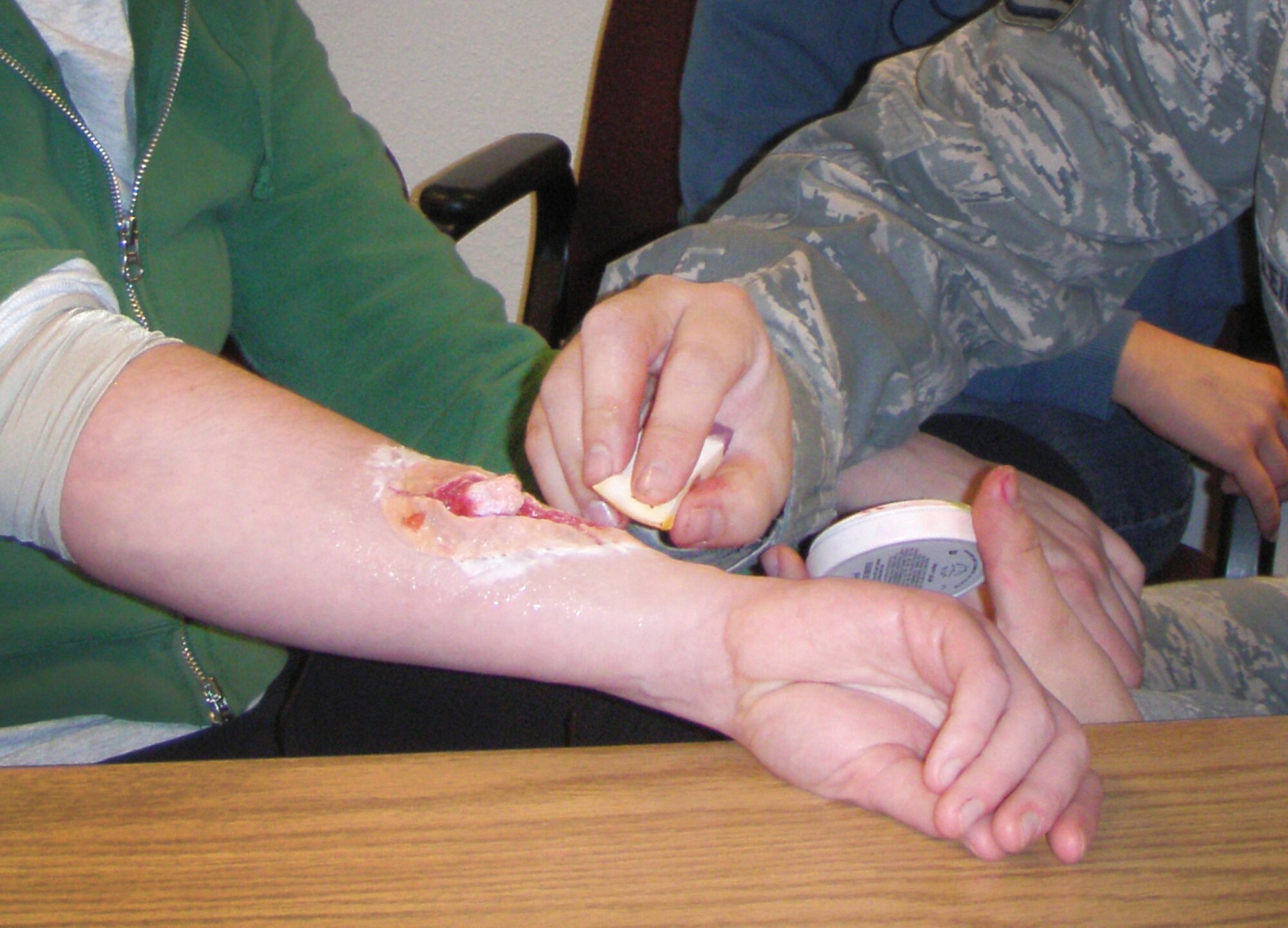 U.S. Air Force Staff Sgt. Daniel Leigh, 27th Special Operations Medical Operations Squadron, performs Self Aid Buddy Care on a simulated injury during a 27th Special Operations Wing exercise at Cannon Air Force Base, N.M., Feb. 13, 2012. Base personnel were evaluated on actions taken in response to two separate incidents and performed well according to post exercise reports. (U.S. Air Force photo by Maj. Steven Kohut)  