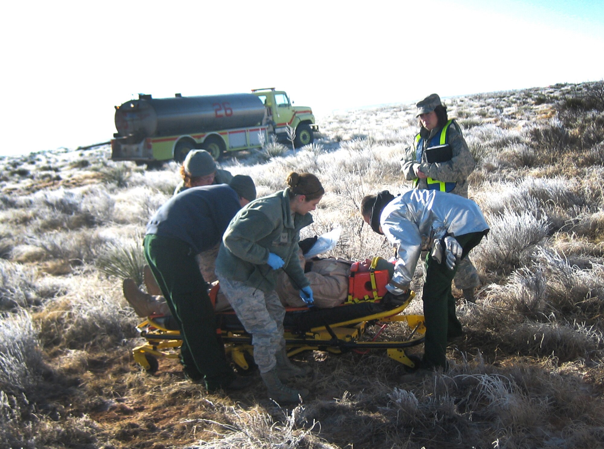 U.S. Air Force Senior Master Sgt. Lorilee Draper, 27th Special Operations Medical Operations Squadron superintendent, evaluates emergency medical technicians responding to a simulated injury during a 27th Special Operations Wing exercise at Melrose Air Force Range, N.M., Feb. 13, 2012. Base personnel were evaluated on actions taken in response to two separate incidents and performed well according to post exercise reports. (U.S. Air Force photo by Maj. Mike Janssen)  