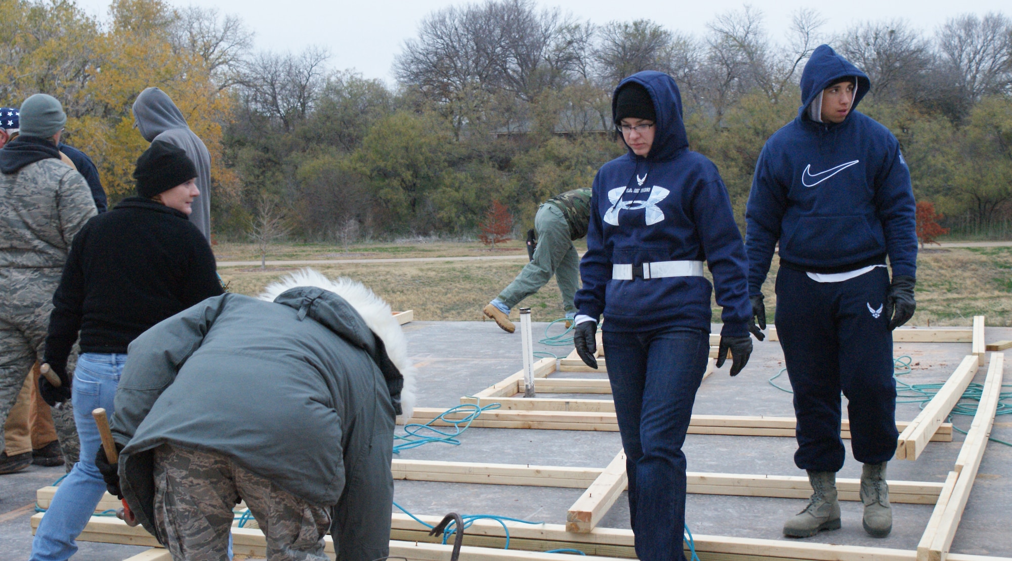 Airmen from the 362nd Training Squadron begin work on a Habitat for Humanity homeon Dec. 6, 2011 in Wichita Falls, Texas.  Members of the 362nd Training Squadron from Sheppard AFB, Texas recently completed the first-ever home build by an all-military manned volunteer crew for the Wichita Falls, Texas, Habitat for Humanity.  (U.S. Air Force photo/Dan Hawkins)