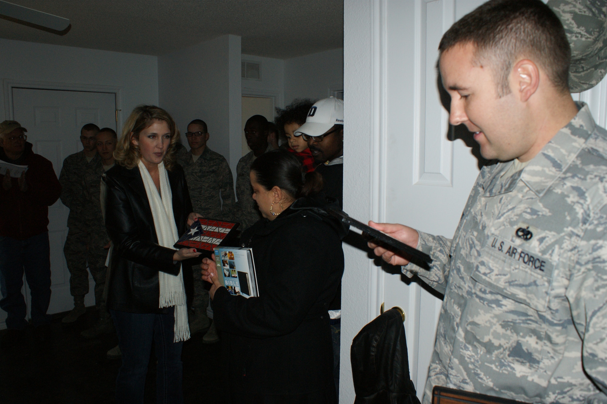 Tech. Sgt. Michael Corbitt from the 362nd Training Squadron receives a special tile in recognition of the unit's volunteer work on a Habitat for Humanity home during a home dedication on Feb. 12, 2012 in Wichita Falls, Texas.  Members of the 362nd Training Squadron from Sheppard AFB, Texas recently participated in the first-ever home build by an all-military manned volunteer crew for the Wichita Falls, Texas, Habitat for Humanity.  (U.S. Air Force photo/Dan Hawkins)