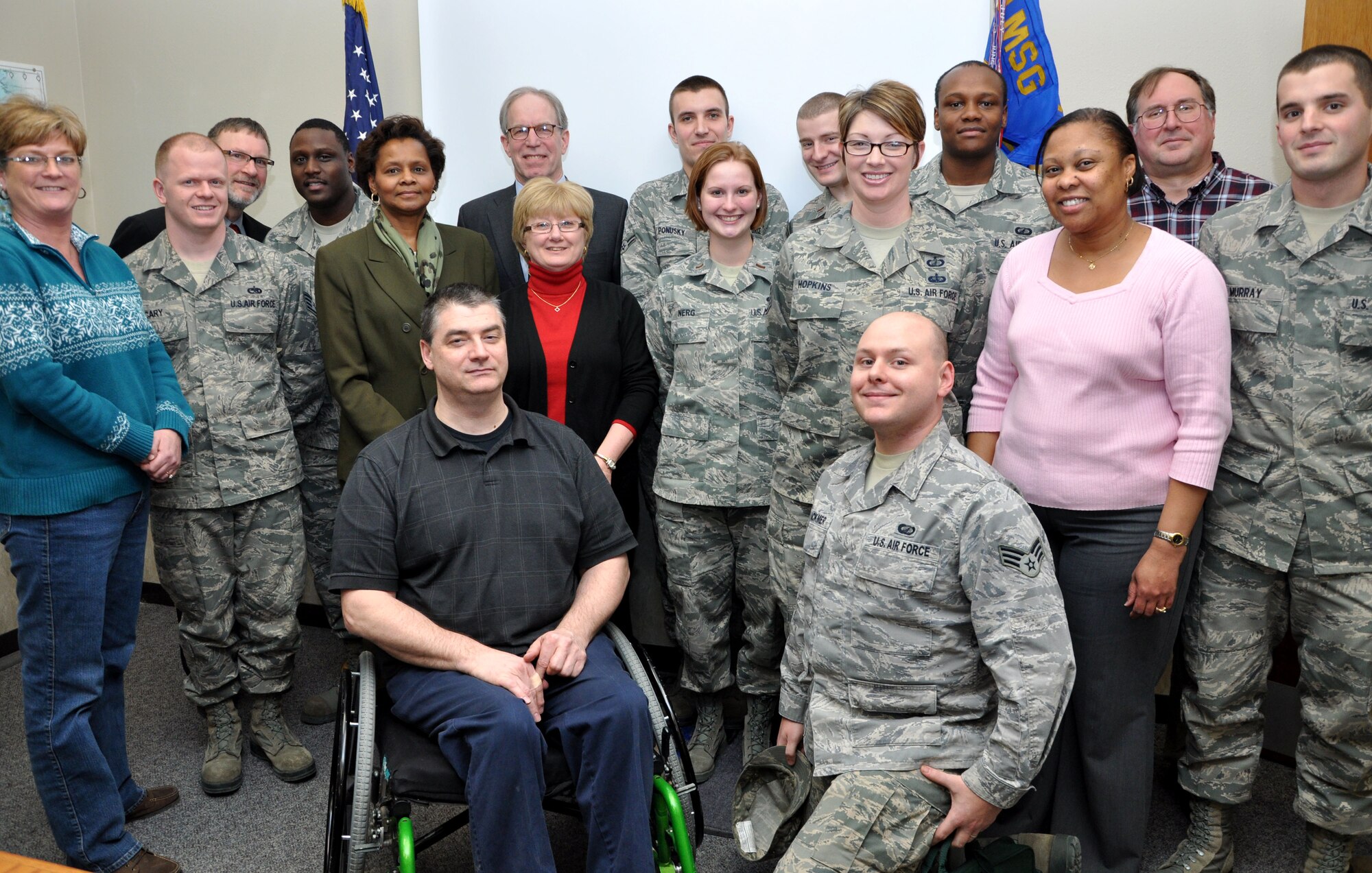 Regional head of the Small Business Administration Dan Hannaher (back center) poses with personnel from the 319th Contracting Flight on Grand Forks Air Force Base, N.D., Feb. 14, 2012.Hannaher visited the base to meet with 319th Air Base Wing Commander Col. Timothy Bush and 319th CONF personnel. He expressed his appreciation for the successful work Grand Forks has consistently accomplished working with the SBA. (U.S. Air Force photo/Airman 1st Class Derek VanHorn)
