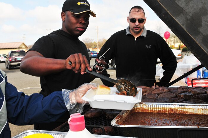 Staff Sgt. Durell Lawton, a member of Team Beale, scoops a healthy serving of baked beans for the Valentine's Day 'Hearty Meal' luncheon on Feb 14, 2012 at Beale Air Force Base, Calif. The lunch includes an 8oz steak with baked beans, dinner roll and a drink. (U.S. Air Force photo by Airman 1st Class Rachael Kane/Released)