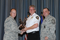The annual Joint Base San Antonio-Randolph award winners were recognized during an awards ceremony at the base theater Feb. 14. Col. Scott Peel, 902nd Mission Support Group commander, left, and Chief Master Sgt. James Erwin, 902nd MSG superintendent, right, present the Supervisor Civilian Category I of the Year Award to Scott Ridenour from the 902nd MSG. (U.S. Air Force photo/Rich McFadden) (released)