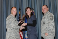 The annual Joint Base San Antonio-Randolph award winners were recognized during an awards ceremony at the base theater Feb. 14. Col. Scott Peel, 902nd Mission Support Group commander, left, and Chief Master Sgt. James Erwin, 902nd MSG superintendent, right, present the Non-Supervisor Civilian Category II of the Year Award to Brenda Wallsmith from the 359th Medical Group. (U.S. Air Force photo/Rich McFadden) (released)