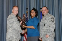 The annual Joint Base San Antonio-Randolph award winners were recognized during an awards ceremony at the base theater Feb. 14. Col. Scott Peel, 902nd Mission Support Group commander, left, and Chief Master Sgt. James Erwin, 902nd MSG superintendent, right, present the Non-Supervisor Civilian Category I of the Year Award to Antoinette Davis from Air Education and Training Command. (U.S. Air Force photo/Rich McFadden) (released)
