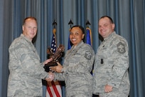 The annual Joint Base San Antonio-Randolph award winners were recognized during an awards ceremony at the base theater Feb. 14. Col. Scott Peel, 902nd Mission Support Group commander, left, and Chief Master Sgt. James Erwin, 902nd MSG superintendent, right, present the First Sergeant of the Year Award to Master Sgt. Yolanda Cole from the 12th Flying Training Wing. (U.S. Air Force photo/Rich McFadden) (released)