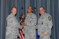 The annual Joint Base San Antonio-Randolph award winners were recognized during an awards ceremony at the base theater Feb. 14. Col. Scott Peel, 902nd Mission Support Group commander, left, and Chief Master Sgt. James Erwin, 902nd MSG superintendent, right, present the Company Grade Officer of the Year Award to Captain Antwan Floyd from the 902nd MSG. (U.S. Air Force photo/Rich McFadden) (released)