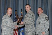 The annual Joint Base San Antonio-Randolph award winners were recognized during an awards ceremony at the base theater Feb. 14. Col. Scott Peel, 902nd Mission Support Group commander, left, and Chief Master Sgt. James Erwin, 902nd MSG superintendent, right, present the Junior Enlisted Airman of the Year Award to Senior Airman Jared Vanwey from the 902nd MSG. (U.S. Air Force photo/Rich McFadden) (released)