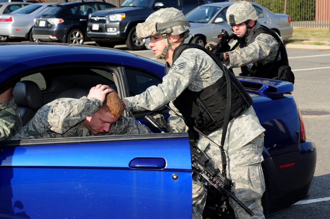 U.S. Air Force Senior Airman Corie Flores apprehends Airman 1st Class Lee Bradberry, both from the 633rd Security Forces Squadron special weapons and tactics team, during a training session at Langley Air Force Base, Va., Feb. 10, 2012. The sustainment-concept training teaches installation protection and defense to security force personnel. (U.S. Air Force photo by Airman 1st Class Kayla Newman/Released)