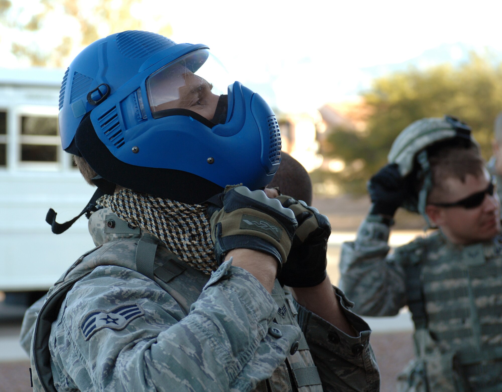 A Senior Airman from the 355th Security Forces Squadron dons his protective head gear as he prepares to begin active shooter training on Davis-Monthan Air Force Base, Ariz., Feb. 9. Instead of blanks, simunitions were used for the training, which requires protection when used. (U.S. Air Force photo by Airman 1st Class Michael Washburn/Released) 