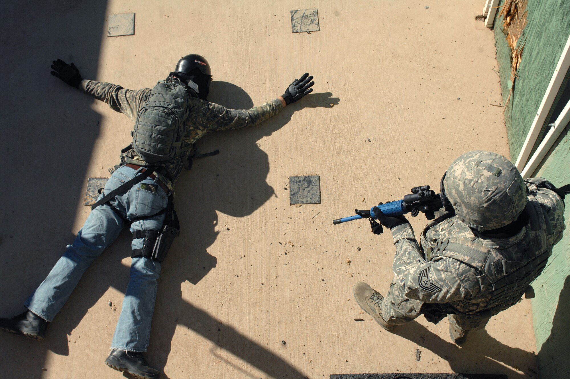 An Airman from the 355th Security Forces Squadron covers a suspect during the active shooter training at Tucson, Ariz., Feb. 9. This scenario consisted of security forces entering a multi-room building, and clearing and securing the rooms one by one. (U.S. Air Force photo by Airman 1st Class Michael Washburn/Released)