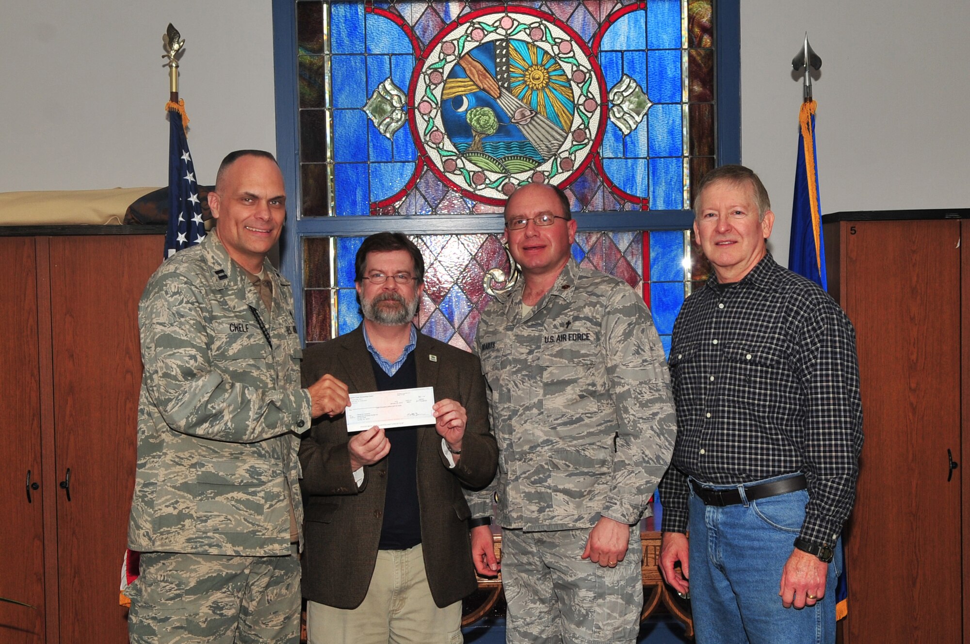 U.S. Air Force Capt. Kevin Chelf, 20th Fighter Wing chaplain, Maj. Matthew Boarts, 20th Fighter Wing chaplain, and Hugh Wilson, young adult ministry coordinator, present a check to Derek Burress, Sumter Habitat for Humanity, executive director, Shaw Air Force Base, S.C., Feb.14, 2012.The check donated to Habitat for Humanity was worth $8,000 dollars. Team Shaw pulled together to make the donation happen. The protestant advisory council helped decide how the donation would be distributed.  (U.S. Air Force photo by Airman 1st Class Ashley L. Gardner/ Released)
