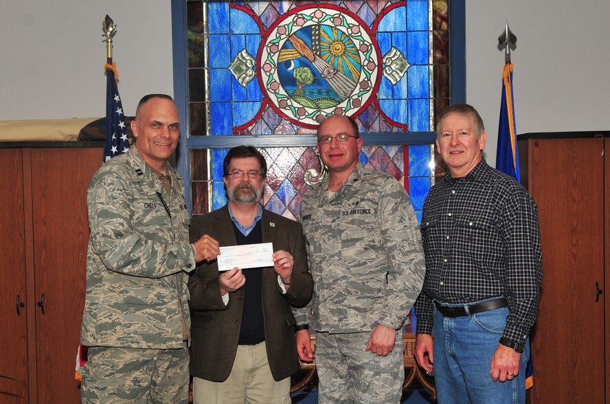 U.S. Air Force Capt. Kevin Chelf, 20th Fighter Wing chaplain, Maj. Matthew Boarts, 20th Fighter Wing chaplain, and Hugh Wilson, young adult ministry coordinator, present a check to Derek Burress, Sumter Habitat for Humanity, executive director, Shaw Air Force Base, S.C., Feb.14, 2012.The check donated to Habitat for Humanity was worth $8,000 dollars. Team Shaw pulled together to make the donation happen. The protestant advisory council helped decide how the donation would be distributed.  (U.S. Air Force photo by Airman 1st Class Ashley L. Gardner/ Released)
