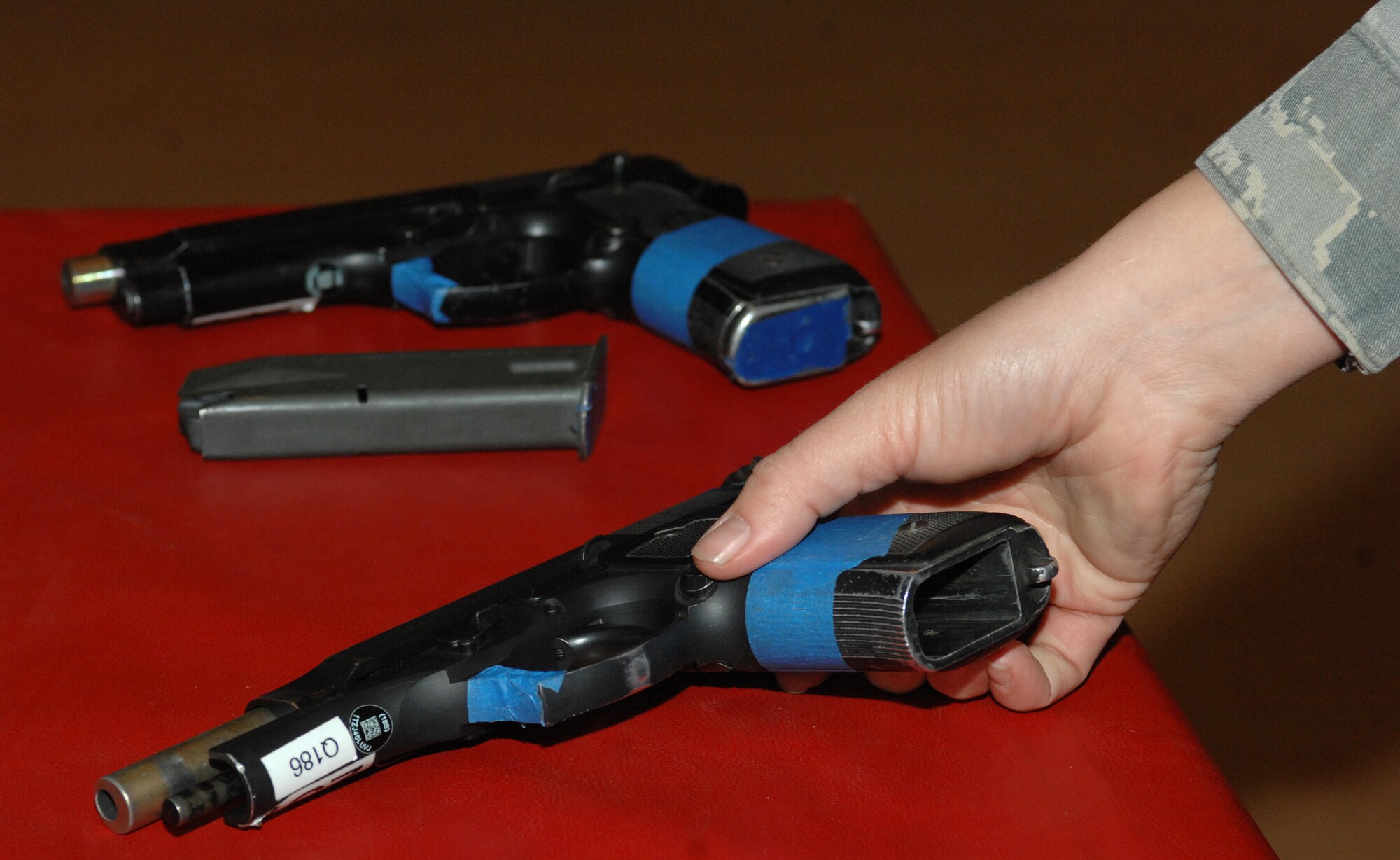 An Airman from the 355th Security Forces Squadron reloads two pistols used by the shooters during the active shooter training at Davis-Monthan Air Force Base, Ariz., Feb. 9. A simunition is a non-lethal round which leaves visible marks when hit. (U.S. Air Force photo by Airman 1st Class Michael Washburn/Released)