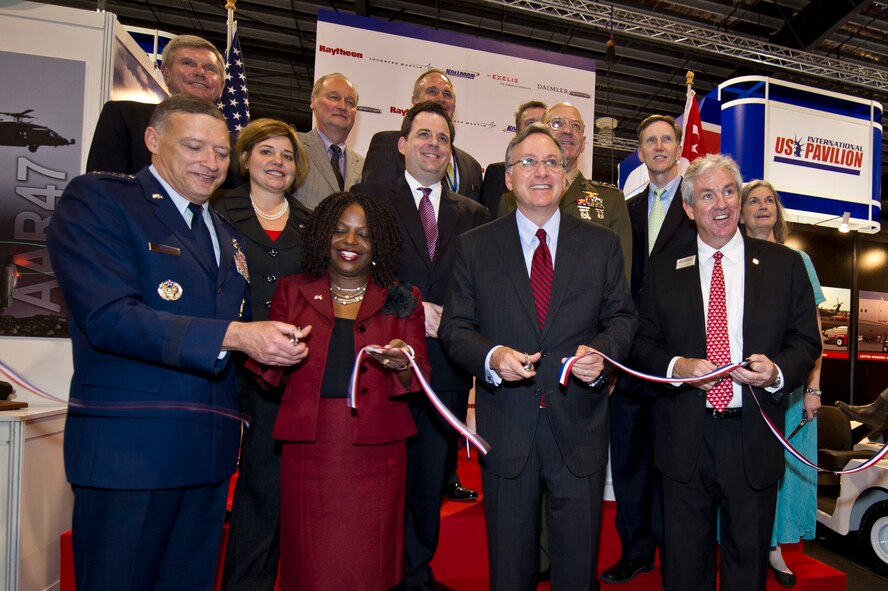 Changi, Singapore -- Gen. Gary North, U.S. Pacific Air Forces commander joined with Ms. Nicole Lamb-Hale, assistant secretary of commerce, and the Honorable David Adelman the U.S. Ambassador to Singapore and air industry leaders for a ceremonial ribbon cutting signifying the official opening of the U.S. Pavilion inside the Changi Exhibition Centre, Feb. 14, 2012, at the 2012 Singapore Air Show. The Bi-Annual Singapore Trade and Air Show is among the three biggest trade shows in the world. (Department of Defense photo by U.S. Air Force Tech. Sgt. Michael R. Holzworth/Released)