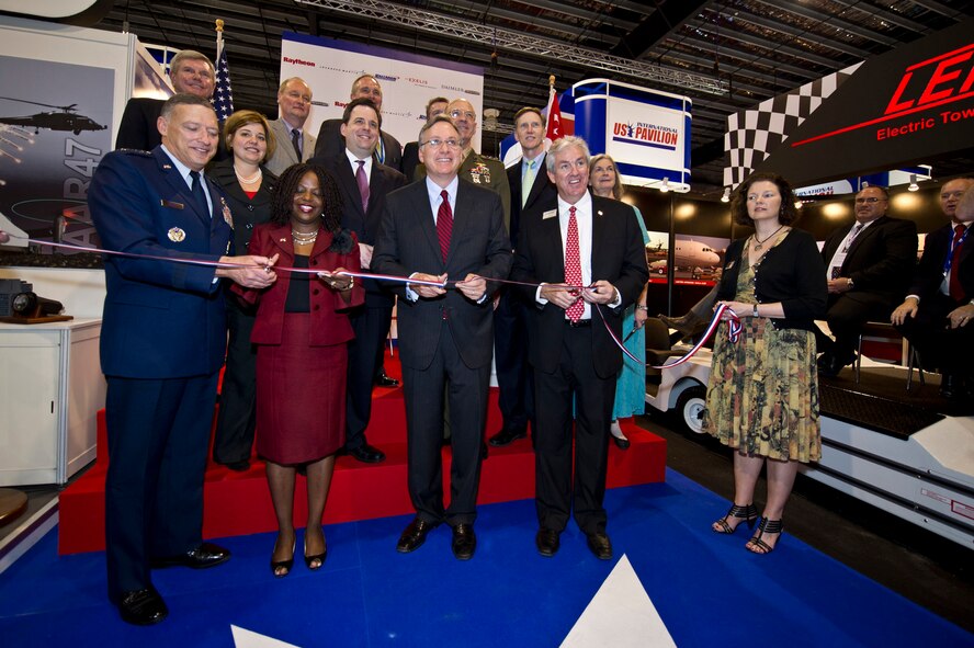 Changi, Singapore -- Gen. Gary North, U.S. Pacific Air Forces commander joined with Ms. Nicole Lamb-Hale, assistant secretary of commerce, and the Honorable David Adelman the U.S. Ambassador to Singapore and air industry leaders for a ceremonial ribbon cutting signifying the official opening of the U.S. Pavilion inside the Changi Exhibition Centre, Feb. 14, 2012, at the 2012 Singapore Air Show. The Bi-Annual Singapore Trade and Air Show is among the three biggest trade shows in the world. (Department of Defense photo by U.S. Air Force Tech. Sgt. Michael R. Holzworth/Released)
