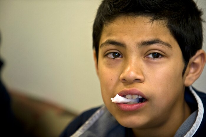 A Las Vegas resident waits to check out after having teeth pulled Feb. 11th, 2012 during Give Kids A Smile at the University of Nevada Las Vegas School of Dentistry. Give Kids A Smile is a national event where dental organizations, including the 99th Dental Squadron, screen and provide education to children in need of dental services. The 99th DS, Nellis Air Force Base, Nev., gives back to the community by participating in the event annually and screened approximately 200 children this year. (U.S. Air Force photo by Senior Airman Brett Clashman)