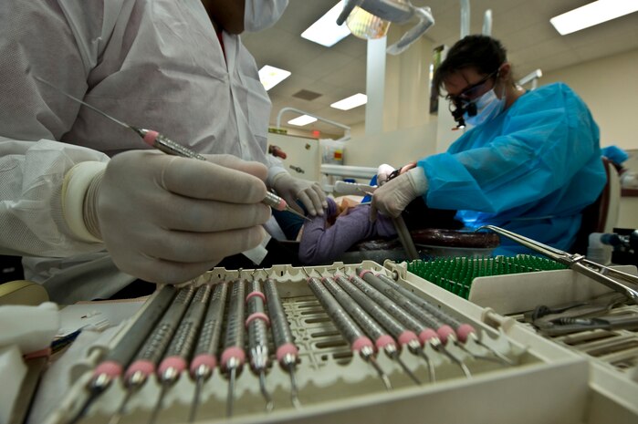Senior Airman Ryan Ngo, 99th Dental Squadron pediatric assistant, readies a scraping tool Feb. 11th, 2012 during Give Kids A Smile at the University of Nevada Las Vegas School of Dentistry. Give Kids A Smile is a national event where dental organizations, including the 99th Dental Squadron, screen and provide education to children in need of dental services. The 99th DS, Nellis Air Force Base, Nev., gives back to the community by participating in the event annually and screened approximately 200 children this year. (U.S. Air Force photo by Senior Airman Brett Clashman)