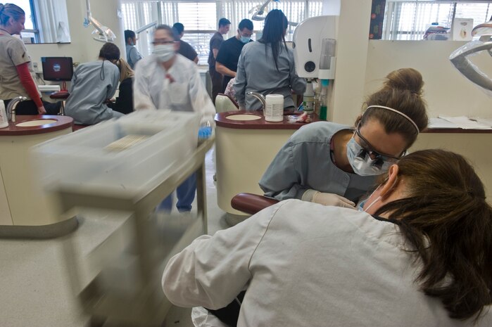 Dental students from University of Nevada Las Vegas, College of Southern Nevada, and 99th Dental Squadron dental hygienists provide dental cleanings to Las Vegas residents Feb. 11th, 2012 during Give Kids A Smile at the University of Nevada Las Vegas School of Dentistry. Give Kids A Smile is a national event where dental organizations, including the 99th Dental Squadron, screen and provide education to children in need of dental services. The 99th DS, Nellis Air Force Base, Nev., gives back to the community by participating in the event annually and screened approximately 200 children this year. (U.S. Air Force photo by Senior Airman Brett Clashman)