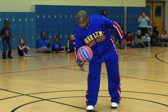 Harlem Globetrotter Shane "Scooter" Christensen demonstrates a basketball trick to members of the Nellis community during his visit Feb. 10th, 2012 at the Youth Center, Nellis Air Force Base, Nev. The Las Vegas native is in his seventh season with the Globetrotters and has played basketball in more than 50 countries during his time on the team. (U.S. Air Force photo by Staff Sgt. Taylor Worley)