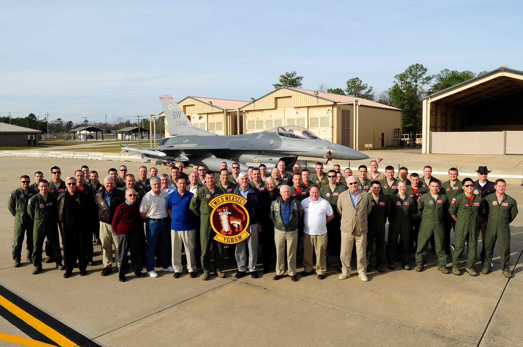 77th Fighter Squadron pilots and the Society of Wild Weasels pose for a group photo at Shaw Air Force Base, S.C., Feb.3, 2012. The Wild Weasel mission was developed by the Air Force in 1965 during the Vietnam War. (U.S. Air Force photo by Airman 1st Class Hunter Brady/Released)