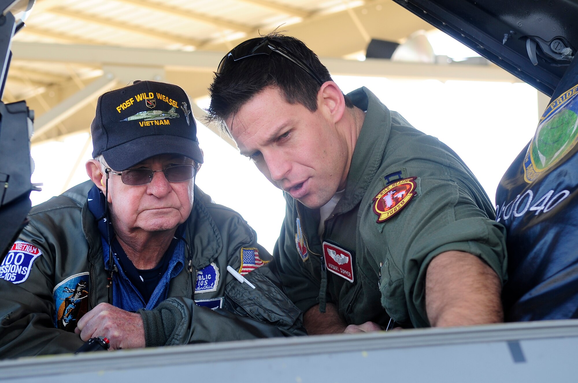 U.S. Air Force Capt. Elijah Supper, 77th Fighter Squadron pilot, shows the mechanics of an F-16 CJ Fighting Falcon to Stan Goldstein, Wild Weasels Society General Secretary, at Shaw Air Force Base, S.C., Feb. 3, 2012. The Wild Weasel mission was developed by the Air Force in 1965 during the Vietnam War. (U.S. Air Force photo by Airman 1st Class Hunter Brady/Released)