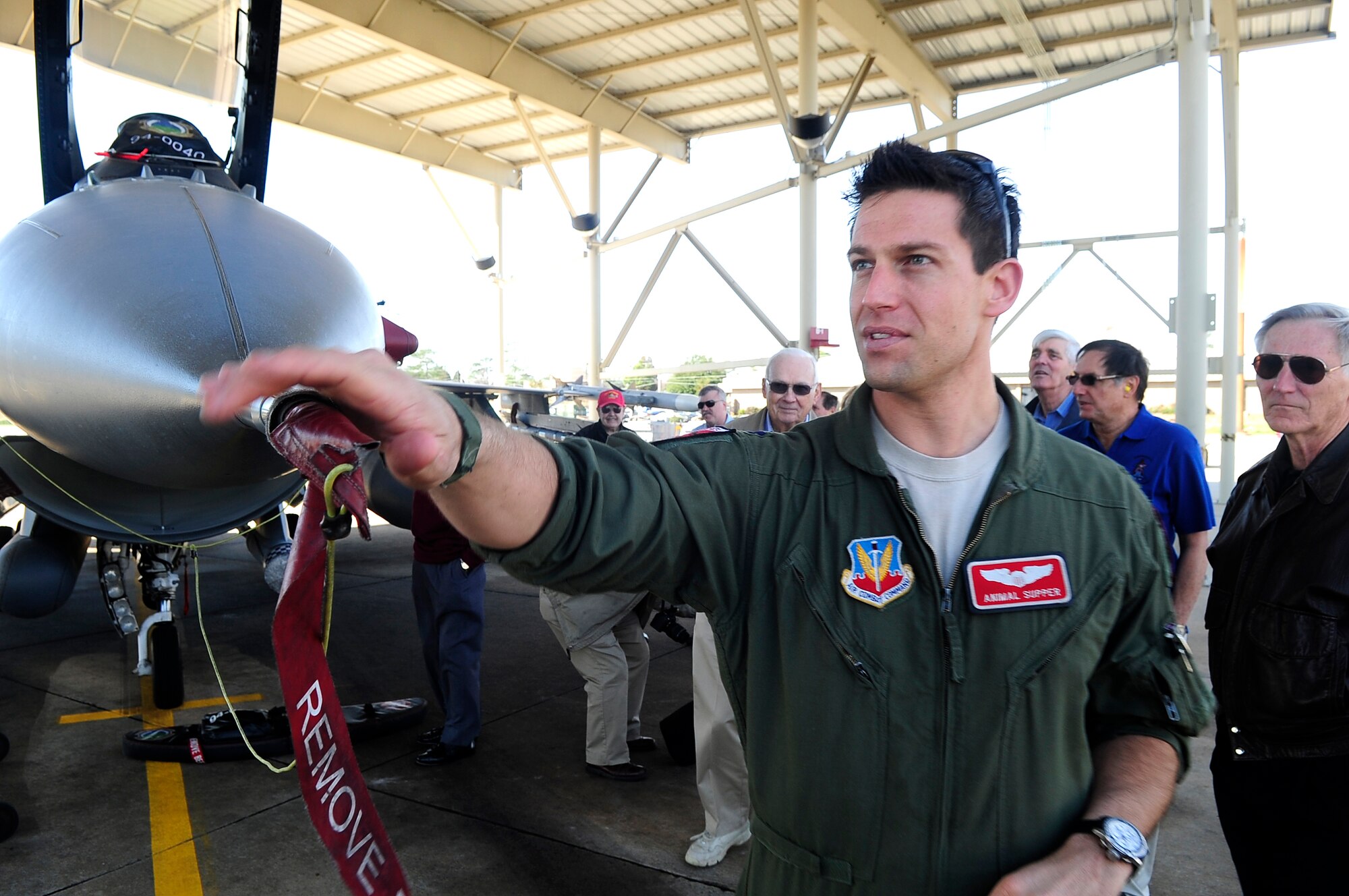U.S. Air Force Capt. Elijah Supper, 77th Fighter Squadron electronic combat pilot, guides the Society of Wild Weasels through a tour of the flightline at Shaw Air Force Base, S.C., Feb. 3, 2011. The Wild Weasel mission was developed by the Air Force in 1965 during the Vietnam War. (U.S. Air Force photo by Airman 1st Class Hunter Brady/Released)