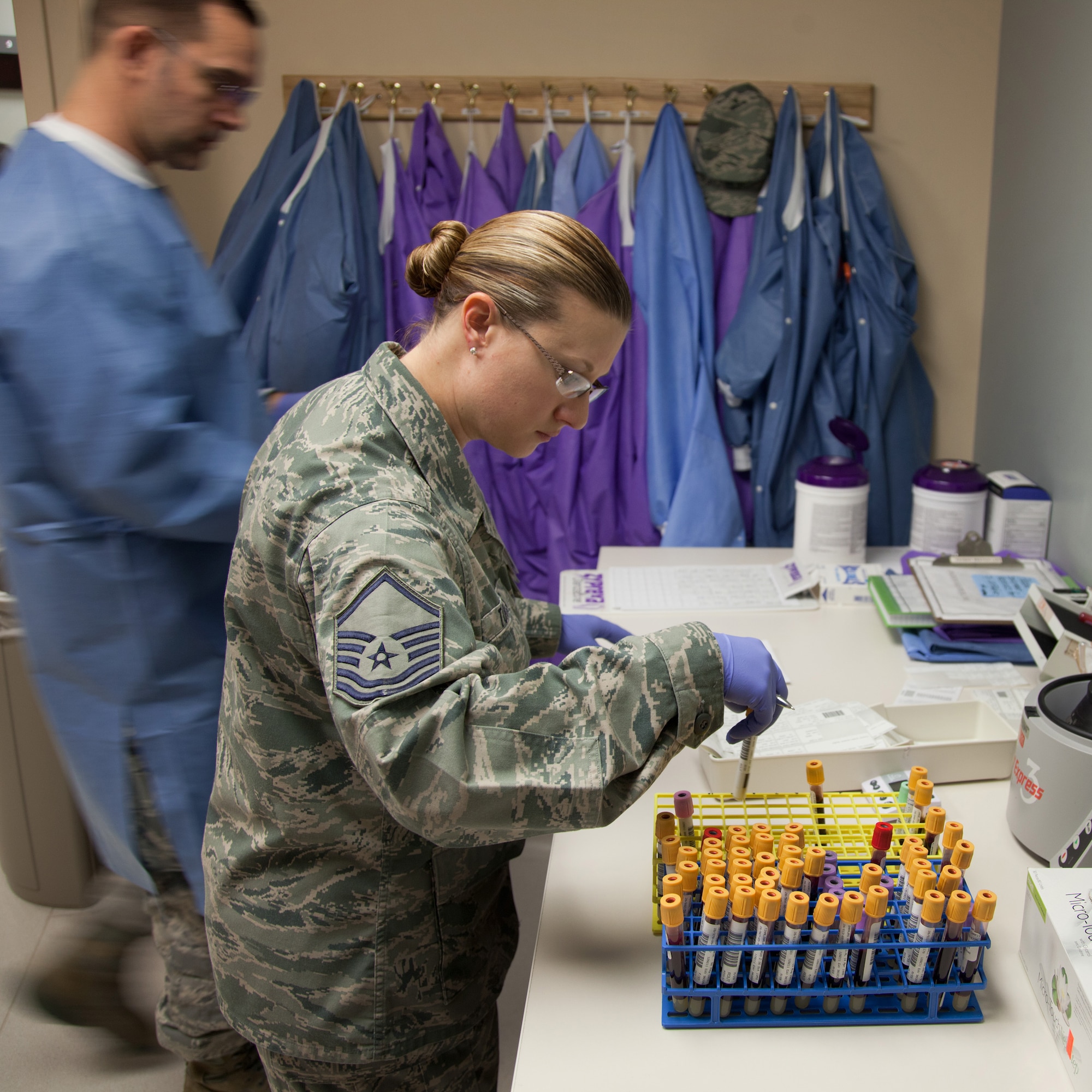 Master Sgt. Sarah Torres, noncommissioned officer in charge of the 349th Aeromedical Medicine Squadron's clinical lab at David Grant USAF Medical Center, quality checks identification on blood-draw containers. Torres is a traditional reservist with the 349th Air Mobility Wing and also a civilian scientist with the 60th Medical Group's Clinical Investigation Facility at DGMC.  (U.S. Air Force photo / Lt. Col. Robert Couse-Baker)