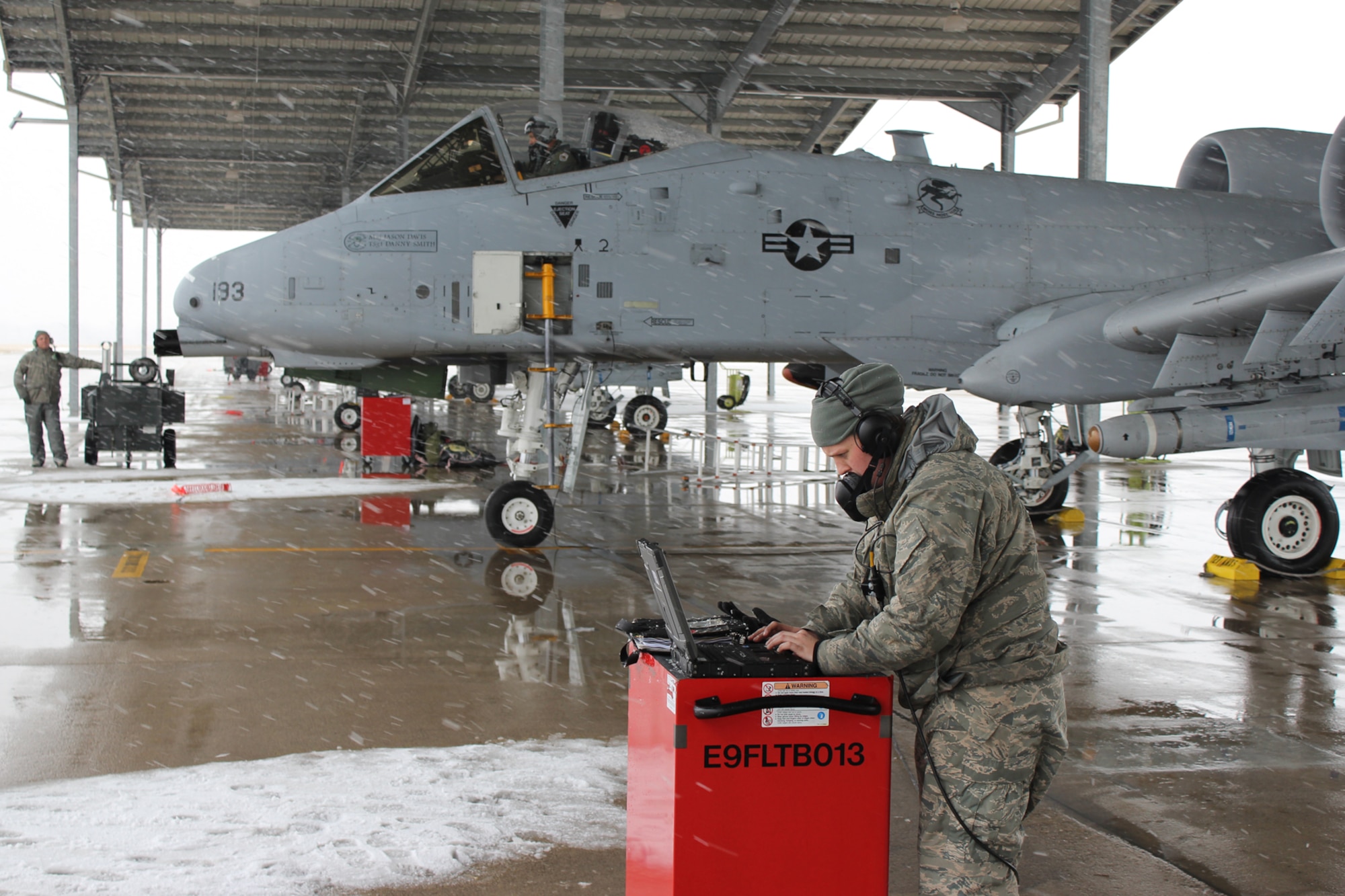 With the snow flying, Senior Airman Amanda Post makes a final check of a technical order shortly before an A-10 Thunderbolt II aircraft taxies to the runway for take off at Selfridge Air National Guard Base, Mich., Feb. 14, 2012. The aircraft’s pilot is Lt. Col. Emmanuel Saridakis, a member of the 107th Fighter Squadron at Selfridge. Post is a crew chief assigned to the 127th Aircraft Maintenance Squadron. The A-10s at Selfridge have resumed a regular local flying and training schedule, following the return of local Airmen from a deployment to Afghanistan. (U.S. Air Force photo by TSgt. Dan Heaton)