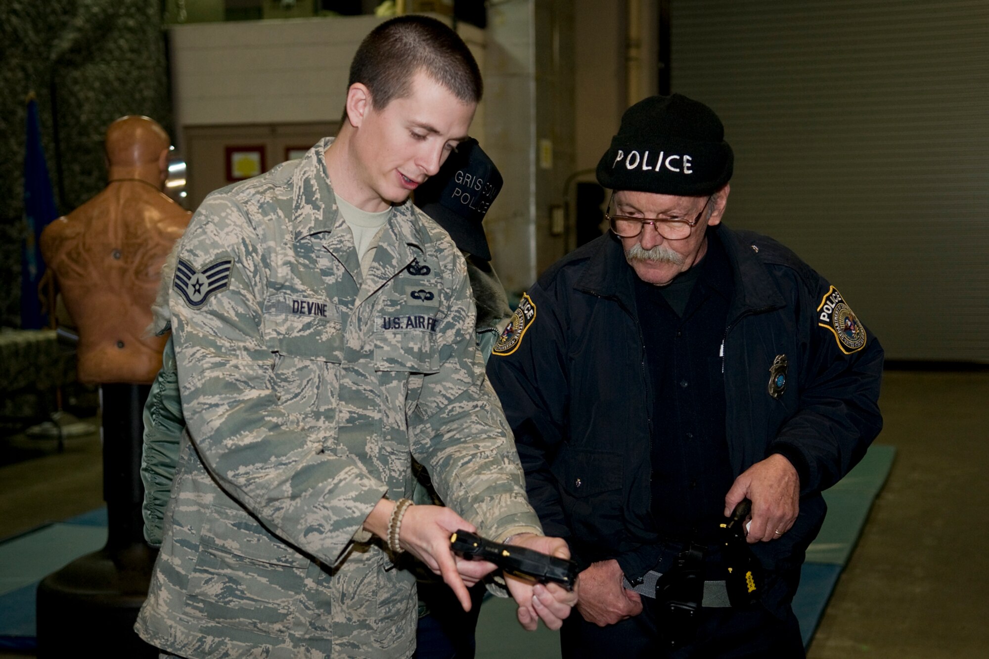 GRISSOM AIR RESERVE BASE, Ind. -- Staff Sgt. Dustin Devine, left, shows Karl Williams how to properly clear an electronic control device during a special training session here Jan. 27. Devine is a 434th Security Forces Squadron security forces journeyman and was responsible for training 434th SFS members. Williams is a Department of Defense police officer. (U.S. Air Force photo/Tech. Sgt. Mark R. W. Orders-Woempner) 
